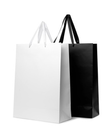 Photo of Paper shopping bags with handles on white background. Mockup for design