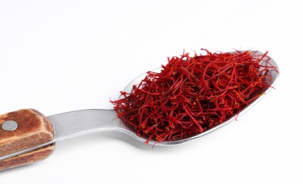 Photo of Aromatic saffron in spoon isolated on white