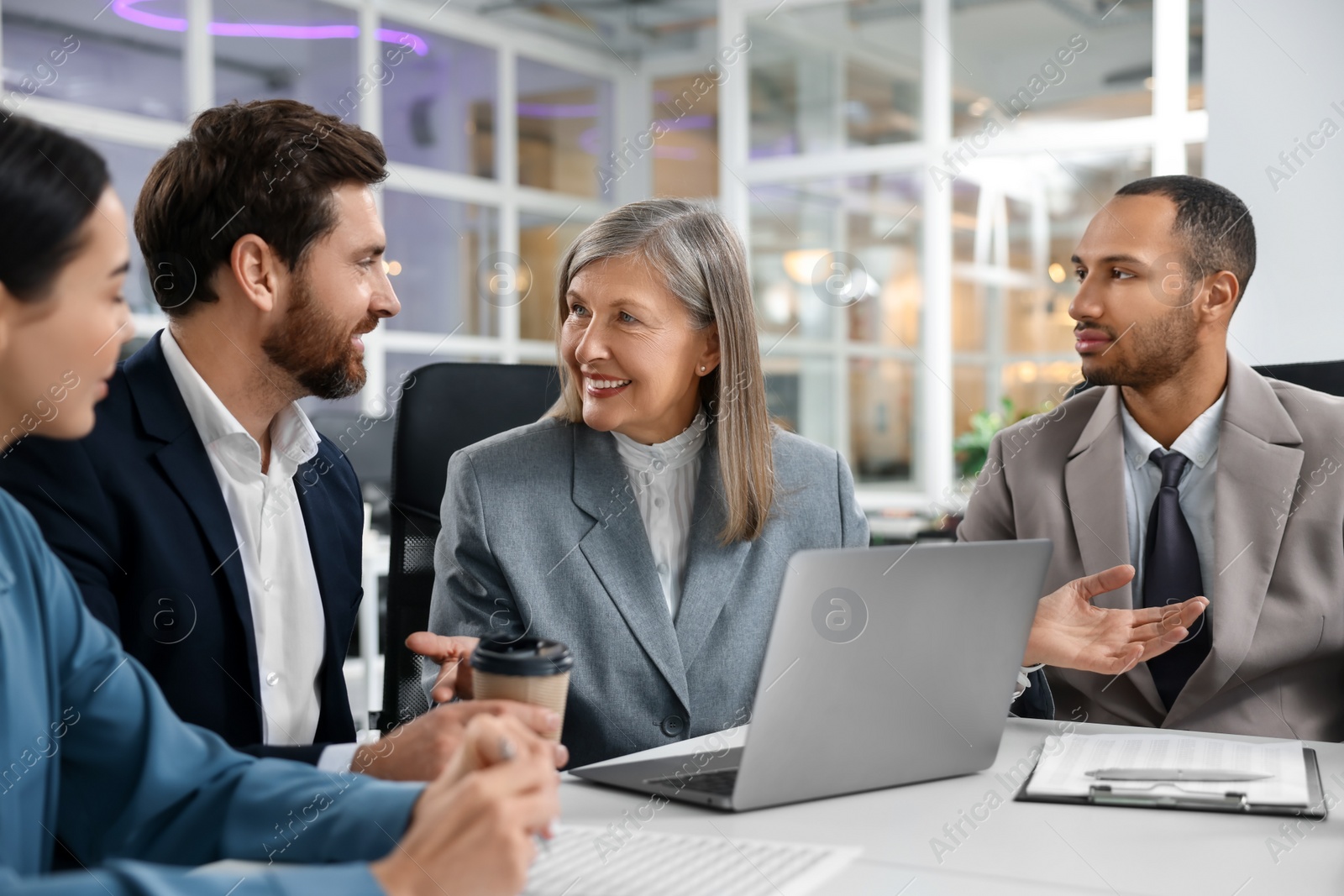 Photo of Lawyers working together at table in office