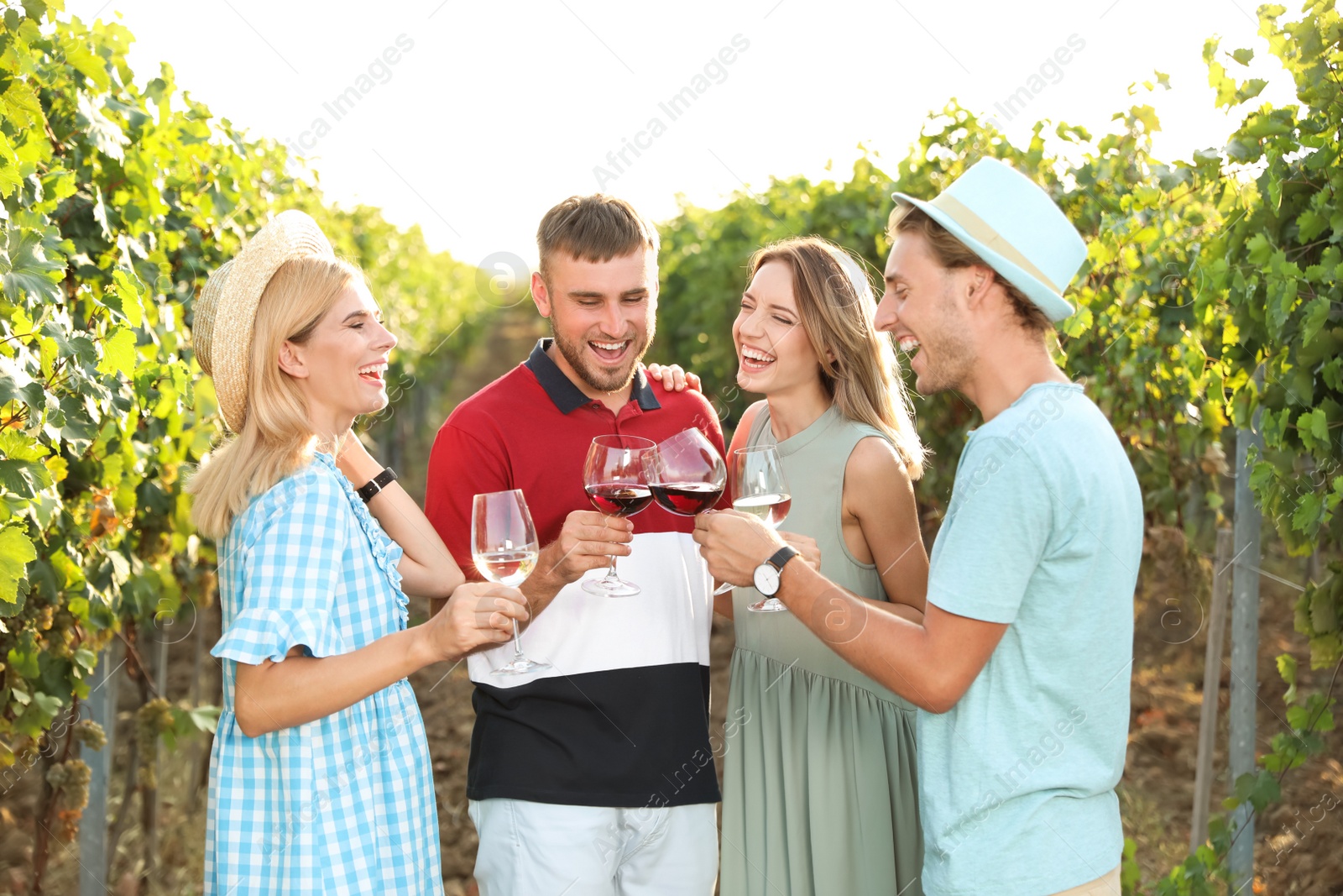 Photo of Friends drinking wine and having fun at vineyard