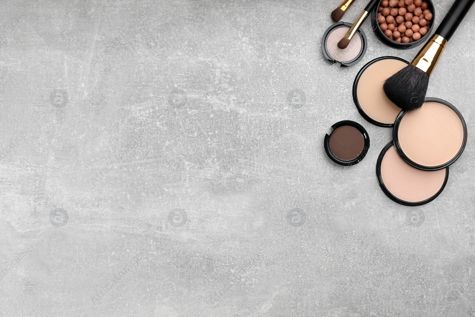 Photo of Flat lay composition with makeup brushes on grey stone table, space for text