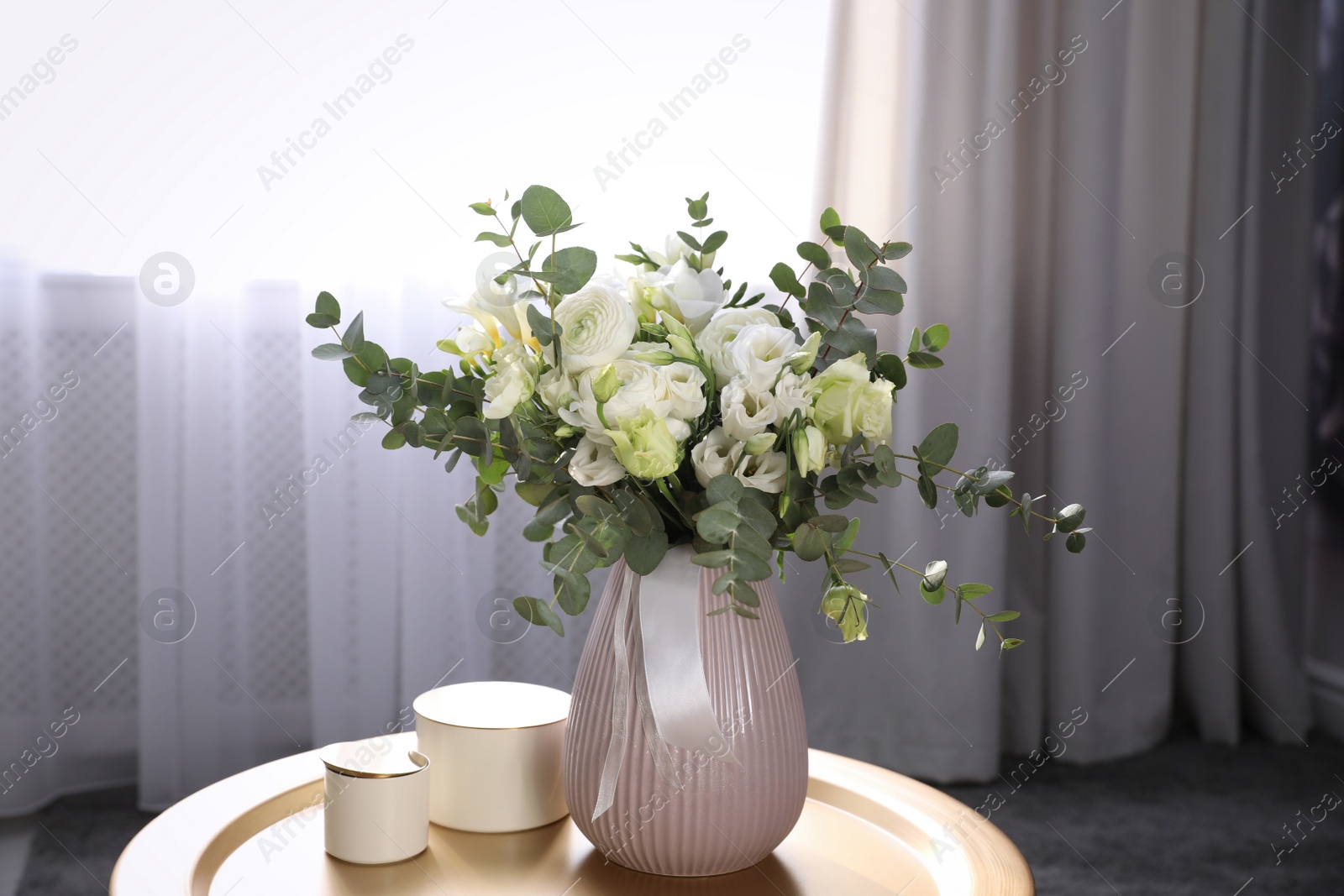 Photo of Beautiful bouquet of flowers on table in room. Stylish interior design