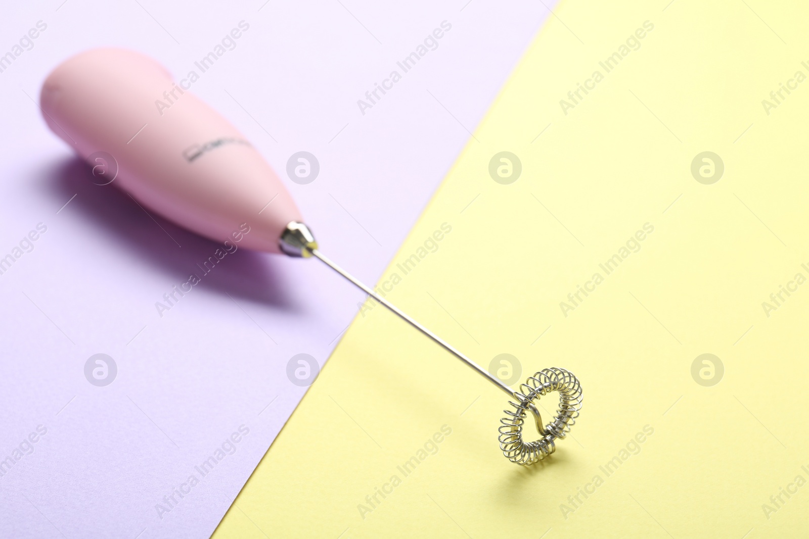 Photo of Pink milk frother wand on color background