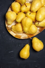 Flat lay composition with fresh ripe pears on dark background