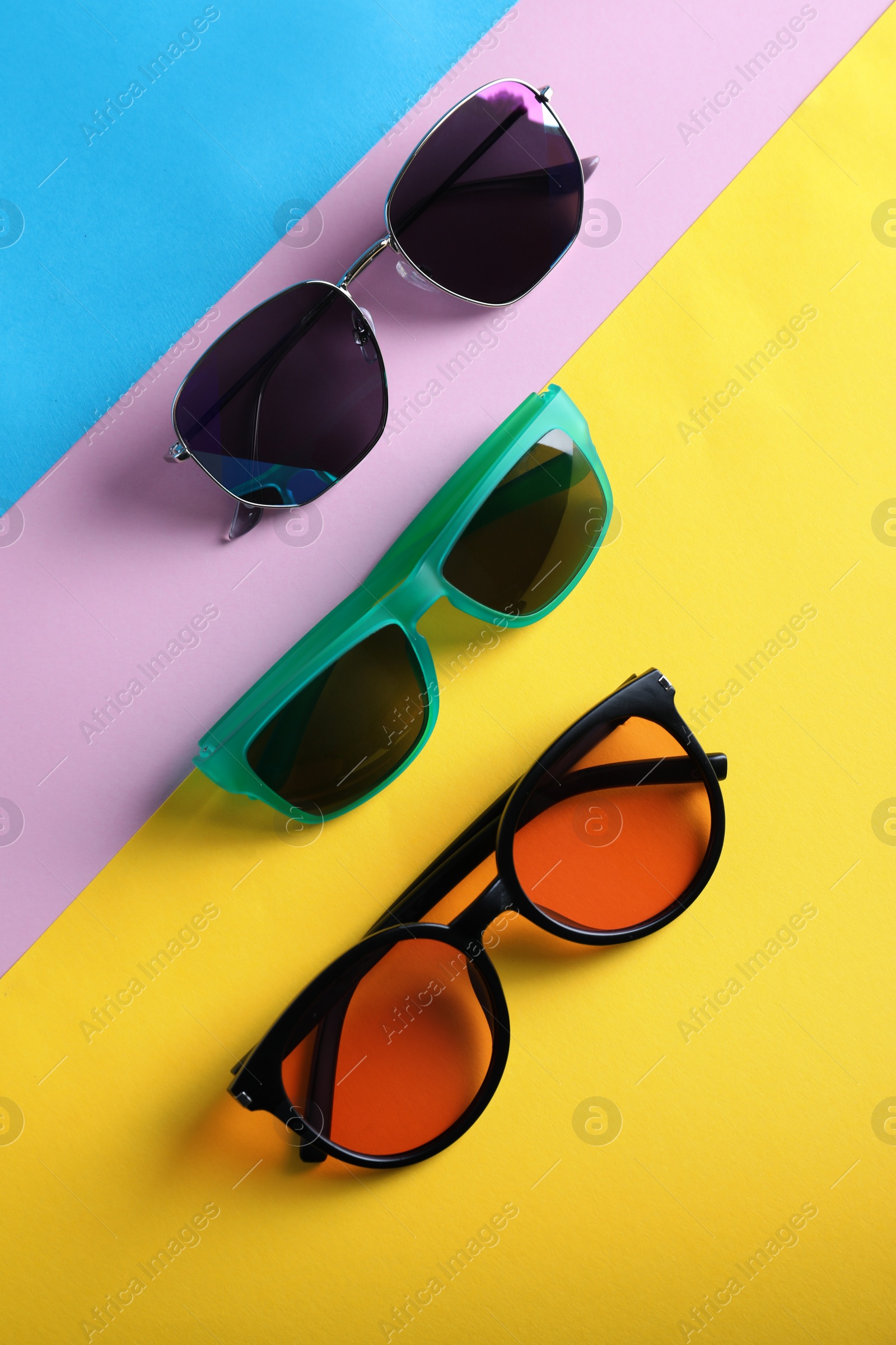 Photo of Many stylish sunglasses on color background, flat lay