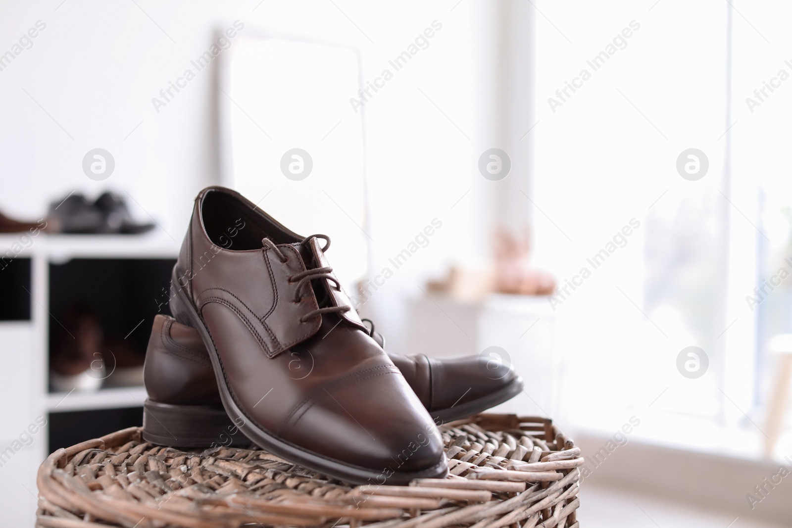 Photo of Male shoes on wicker stand in store