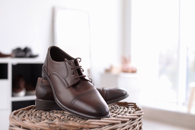 Male shoes on wicker stand in store