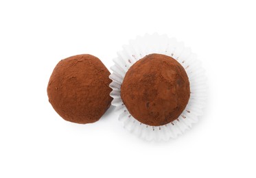 Photo of Delicious chocolate truffles powdered with cocoa on white background