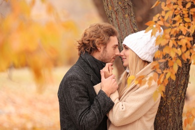 Photo of Young romantic couple in park on autumn day
