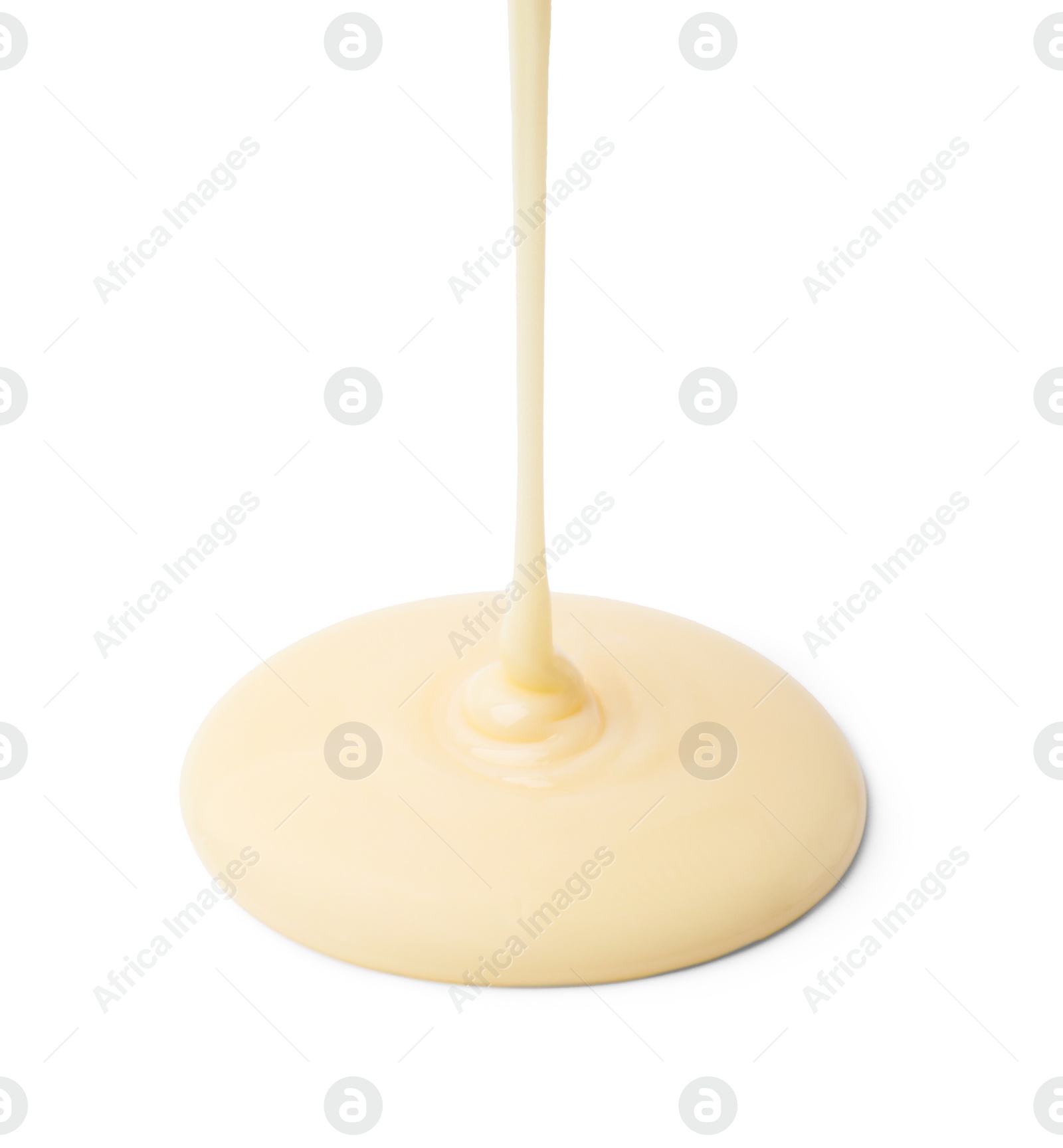 Photo of Pouring tasty condensed milk isolated on white