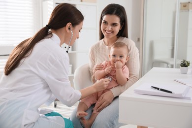 Mother with her cute baby visiting pediatrician in clinic