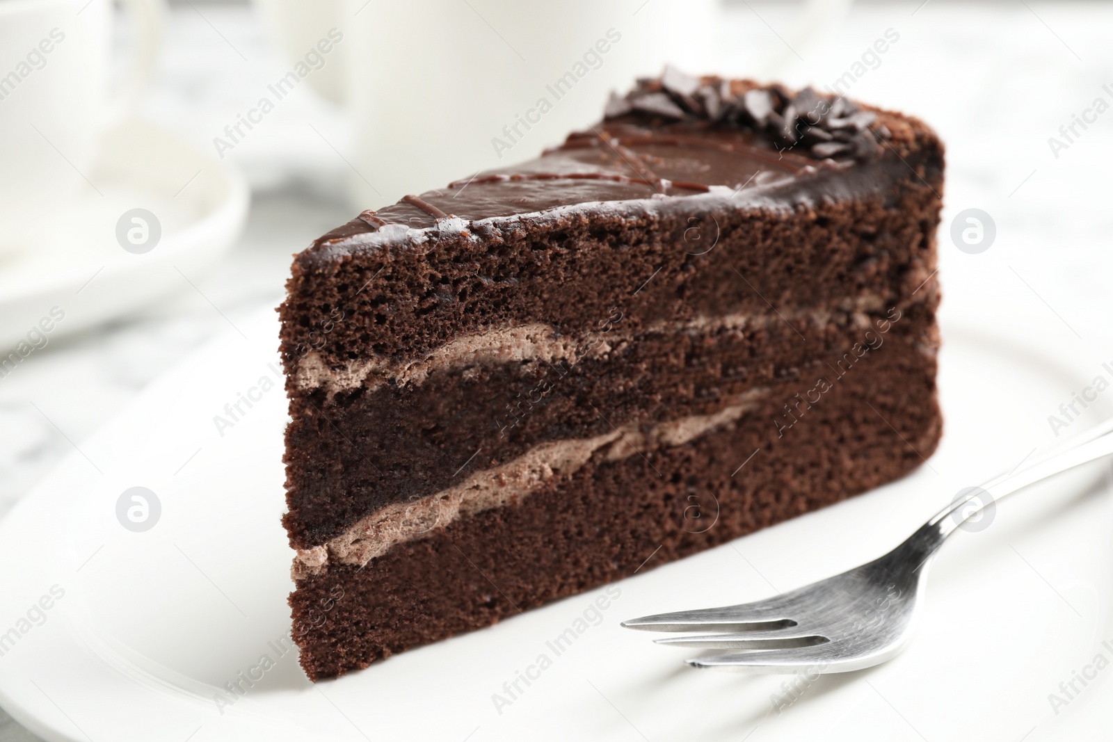 Photo of Piece of tasty chocolate cake served on plate