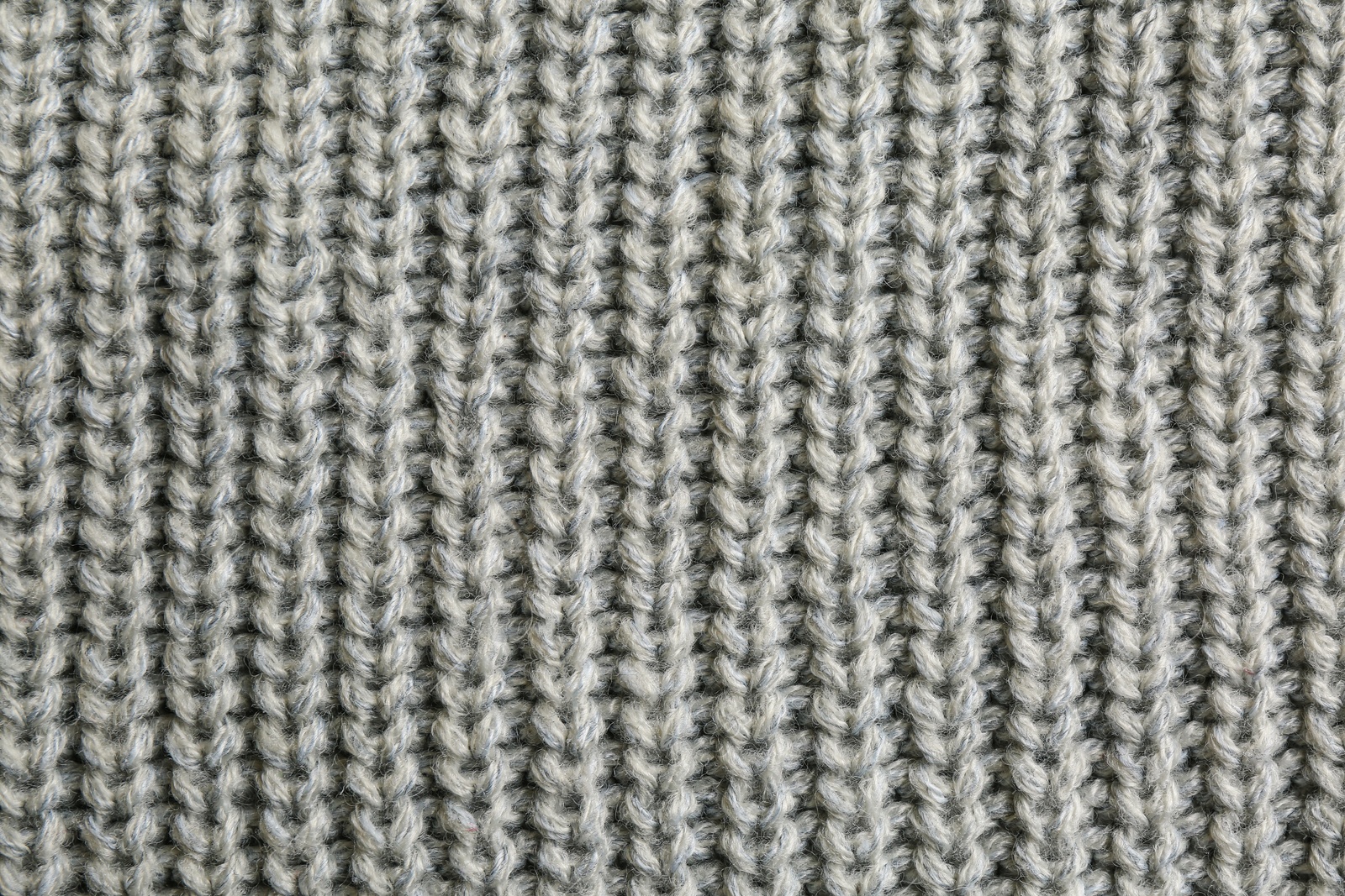 Photo of Beautiful grey knitted fabric as background, top view