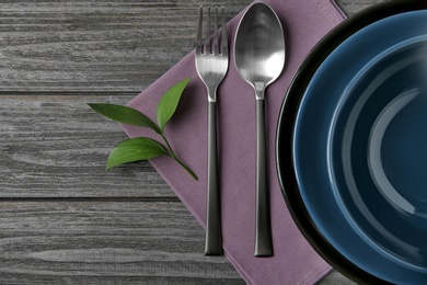 Beautiful table setting on dark wooden background, flat lay