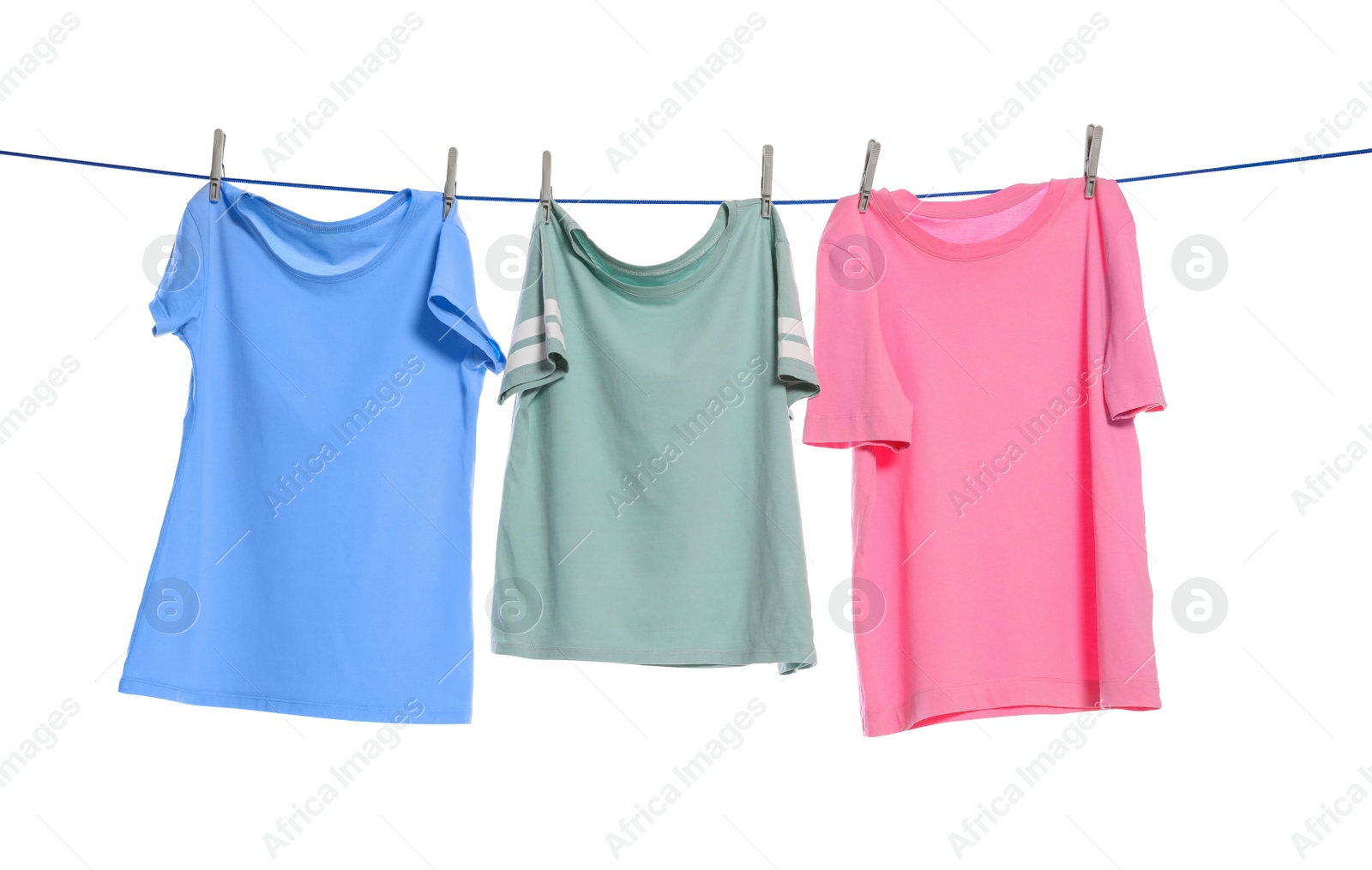 Photo of Different clothes drying on washing line against white background