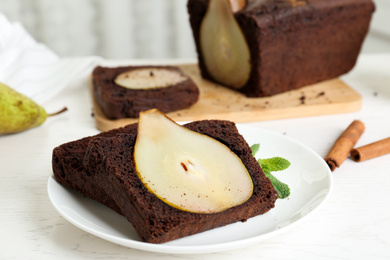 Tasty pear bread served with mint on white wooden table. Homemade cake