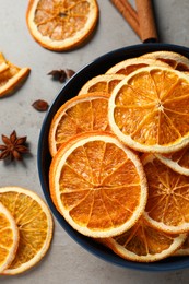 Dry orange slices and anise stars on grey table, flat lay