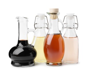 Different types of vinegar isolated on white