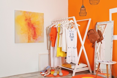 Stylish dressing room interior with clothes rack