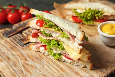 Tasty toast sandwich on wooden board. Wheat bread