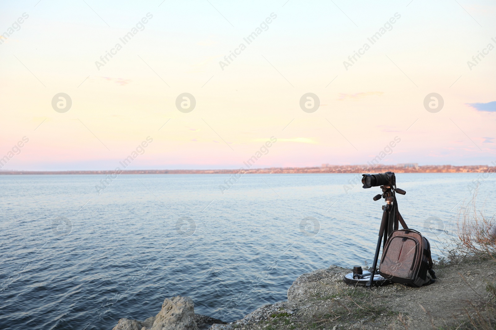 Photo of Professional photography equipment on rocky river coast