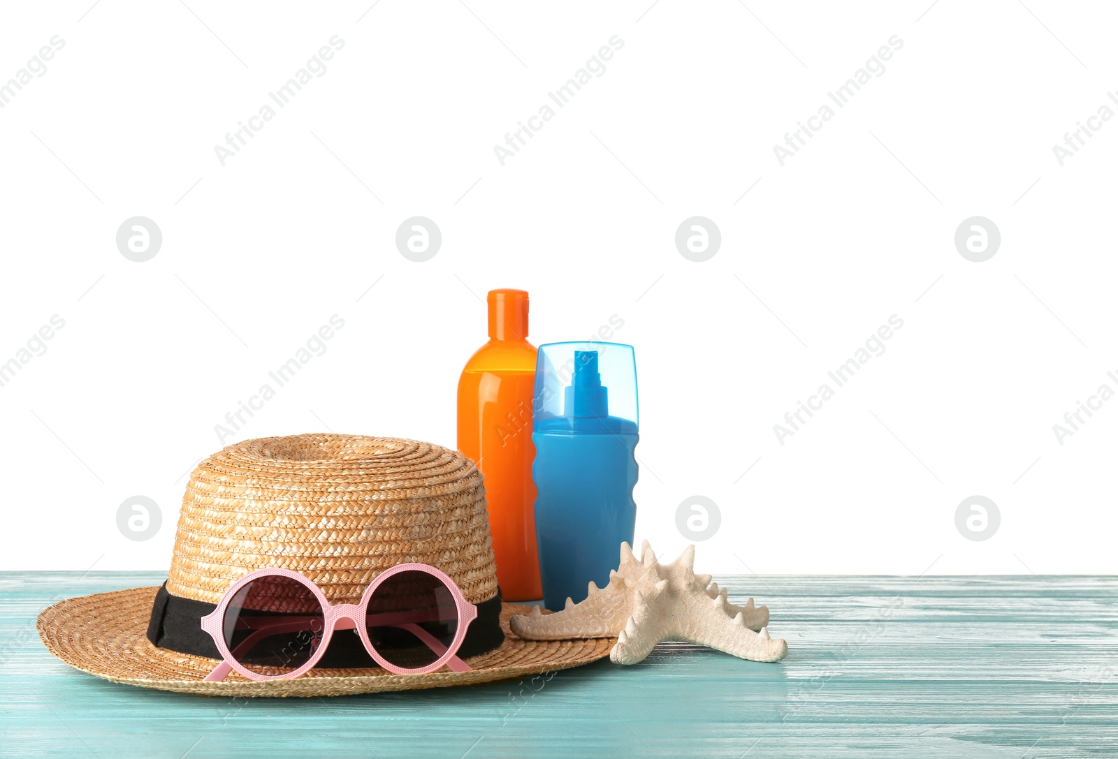 Photo of Set of different beach accessories on table against white background. Space for text