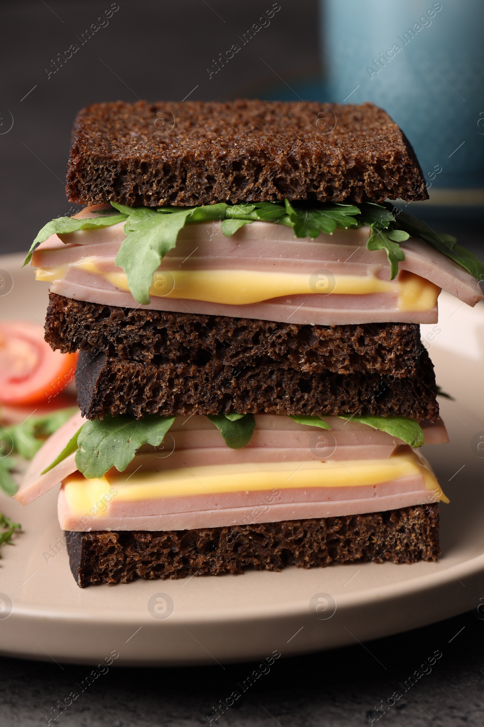 Photo of Delicious sandwiches with boiled sausage, cheese and arugula on table, closeup