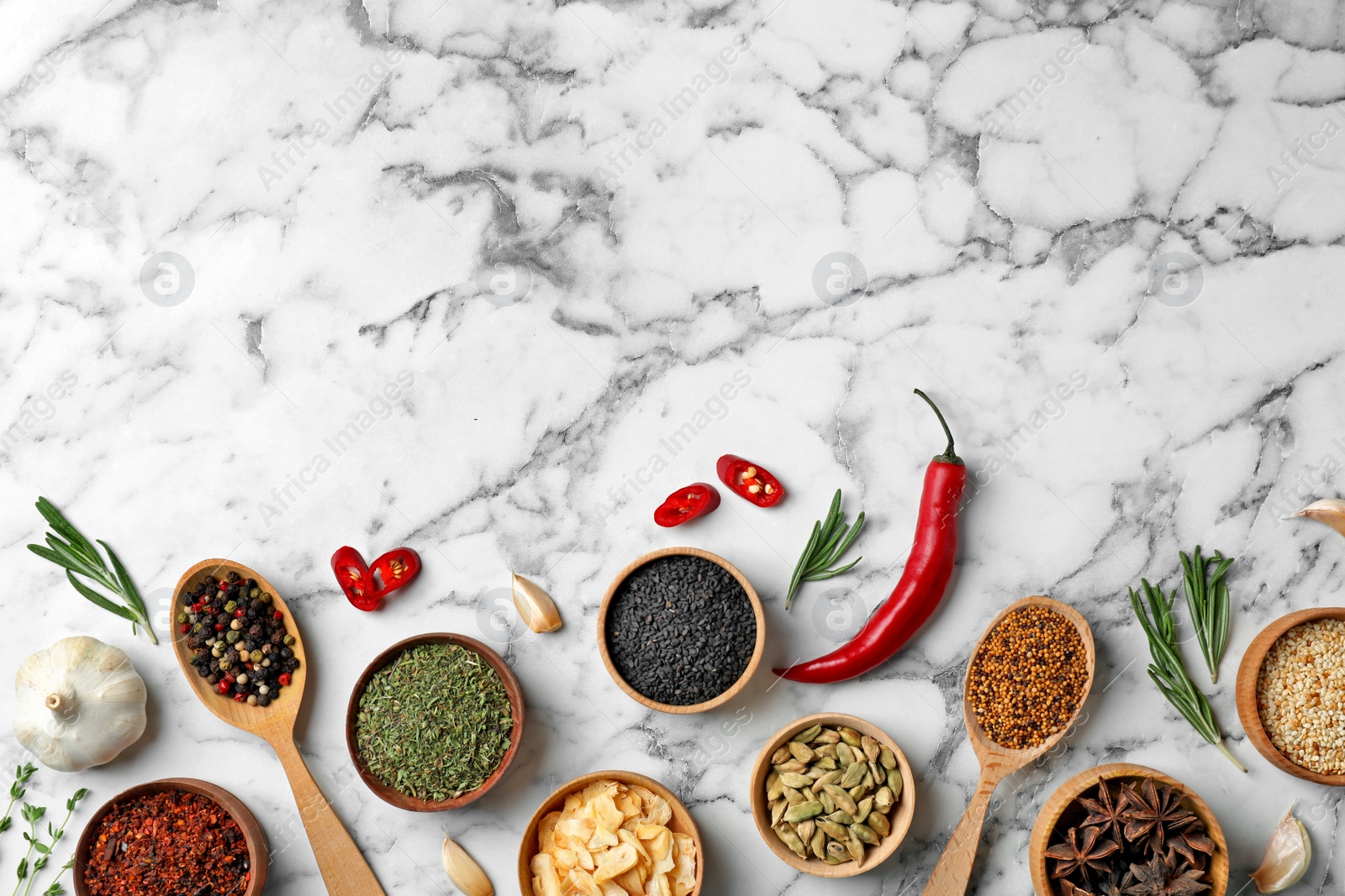 Photo of Flat lay composition with different aromatic spices and space for text on marble background