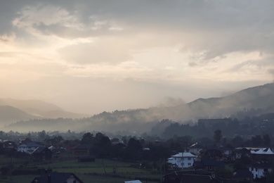 Photo of Picturesque view of mountain village with fog