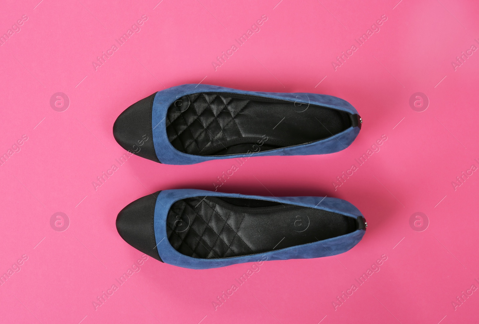 Photo of Pair of female shoes on color background, top view