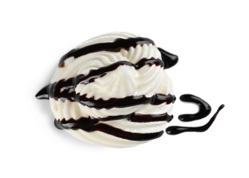 Photo of Delicious fresh whipped cream with chocolate syrup isolated on white, top view