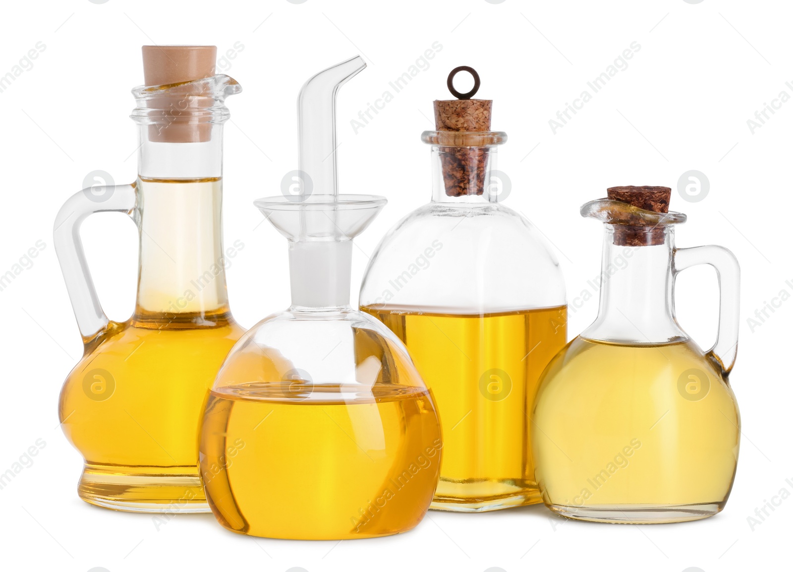 Photo of Different glass bottles of cooking oil on white background