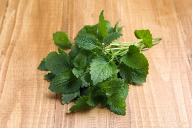 Aromatic fresh lemon balm on wooden table