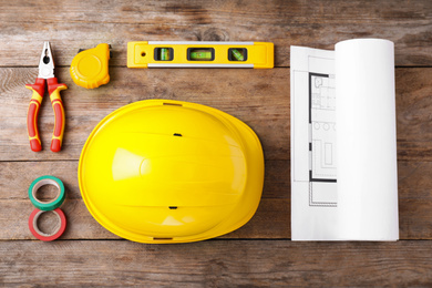 Flat lay composition with construction tools on wooden background