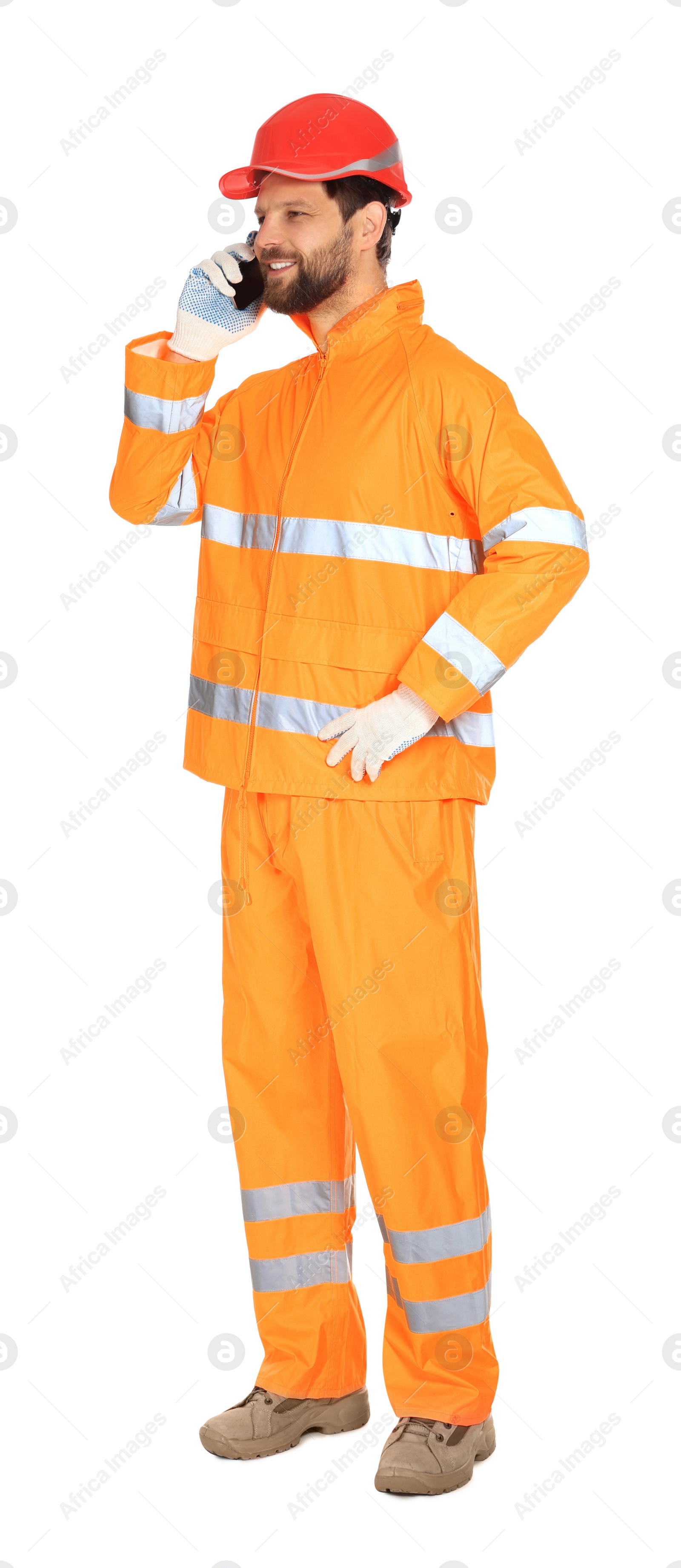 Photo of Man in reflective uniform talking on smartphone against white background