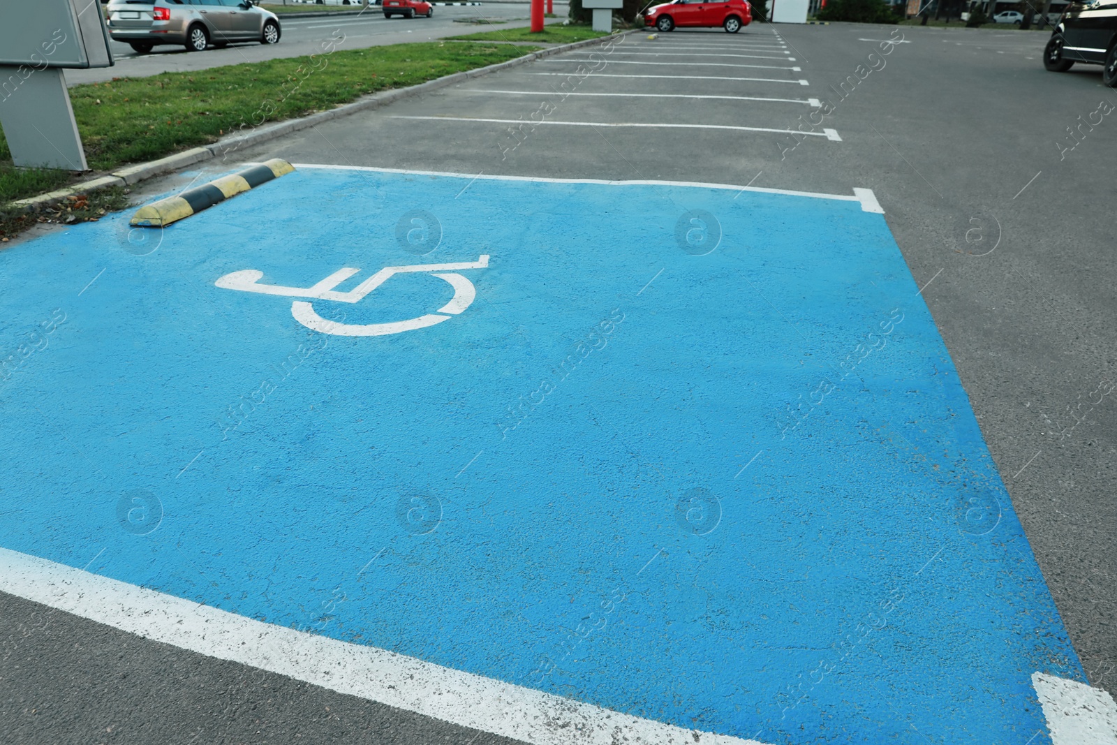 Photo of Car parking lot with handicapped symbol outdoors