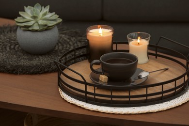Photo of Freshly brewed coffee and decorative elements on wooden table in room