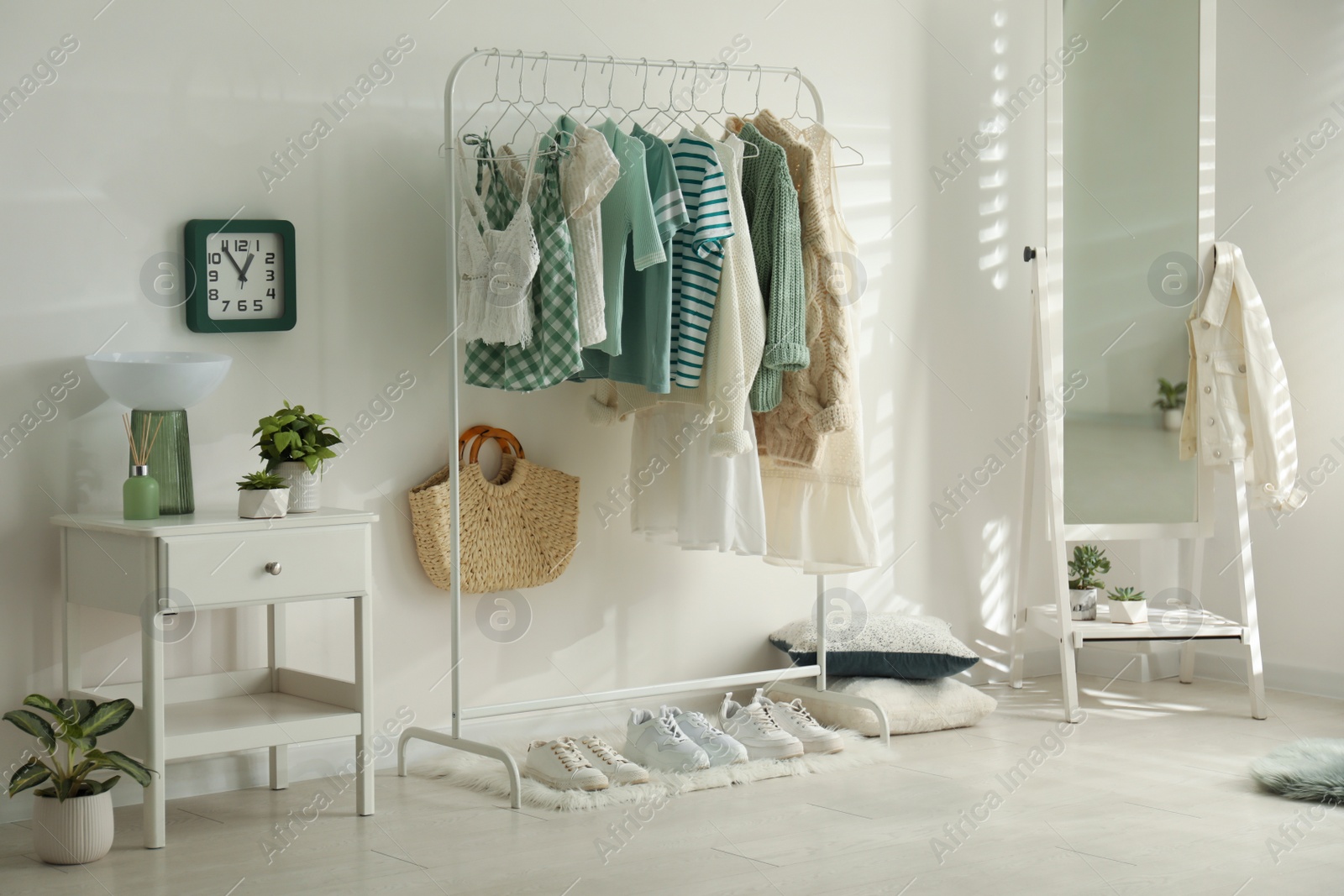 Photo of Dressing room interior with clothing rack and mirror