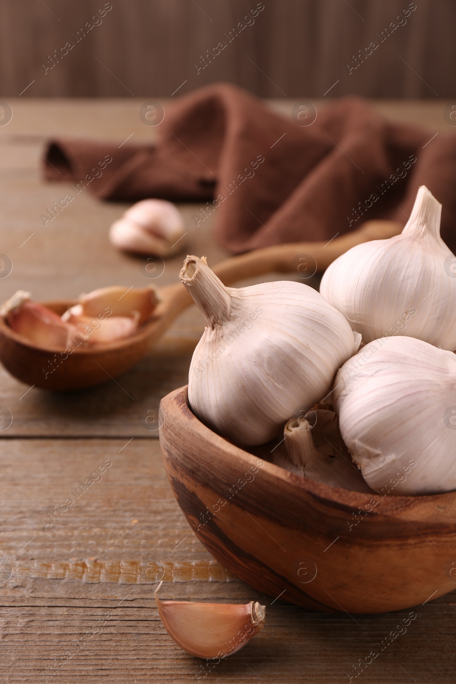 Photo of Fresh garlic on wooden table, closeup view