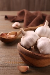 Photo of Fresh garlic on wooden table, closeup view