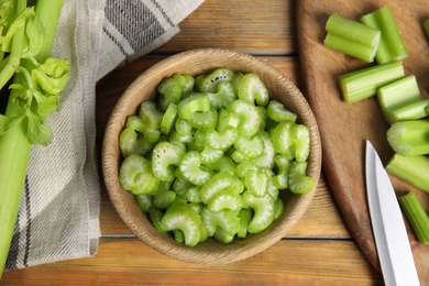 Photo of Fresh ripe celery on wooden table, flat lay