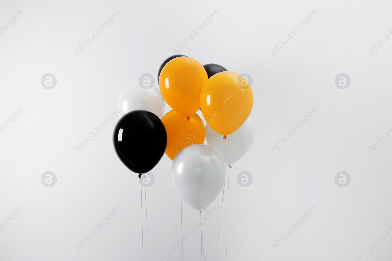 Photo of Colorful balloons on light background. Halloween party