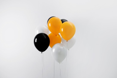 Photo of Colorful balloons on light background. Halloween party
