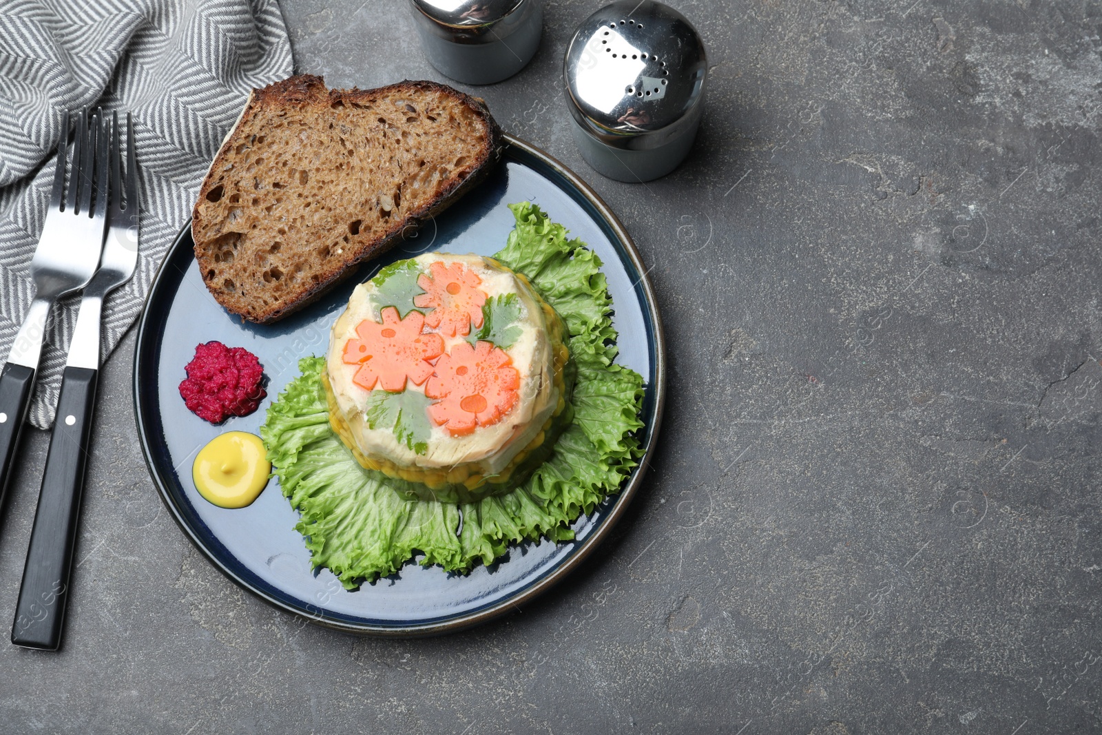 Photo of Delicious chicken aspic served on grey table, flat lay. Space for text