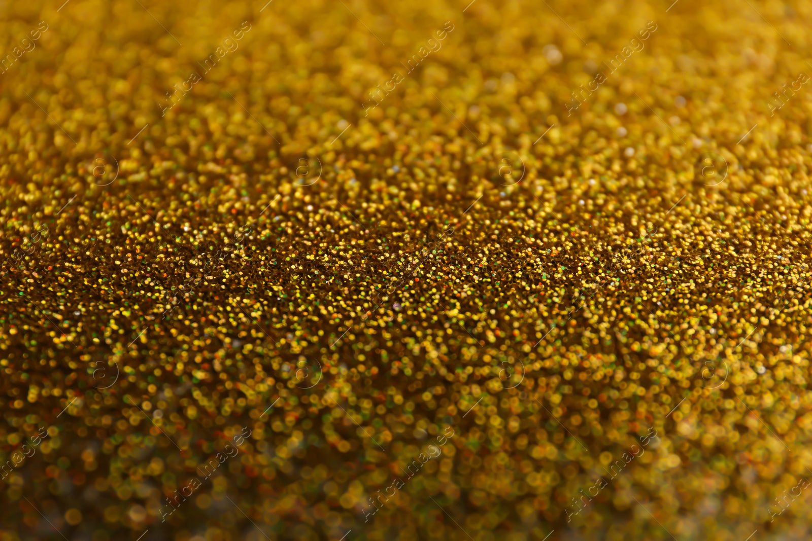 Photo of Closeup view of sparkling golden glitter background