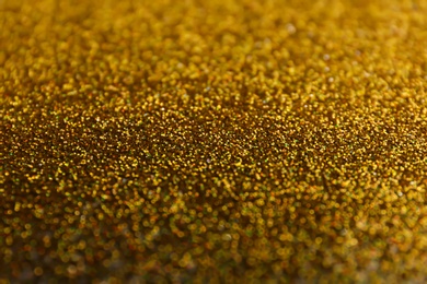 Photo of Closeup view of sparkling golden glitter background