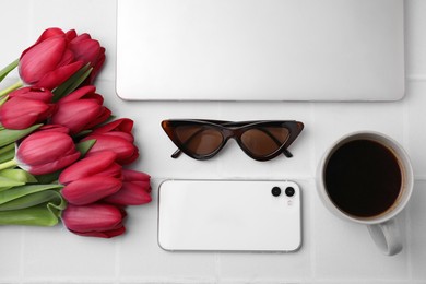Flat lay composition with beautiful tulips and laptop on white table