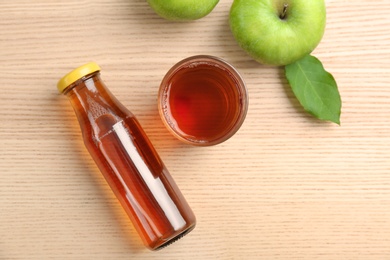 Composition with fresh apple juice on wooden table