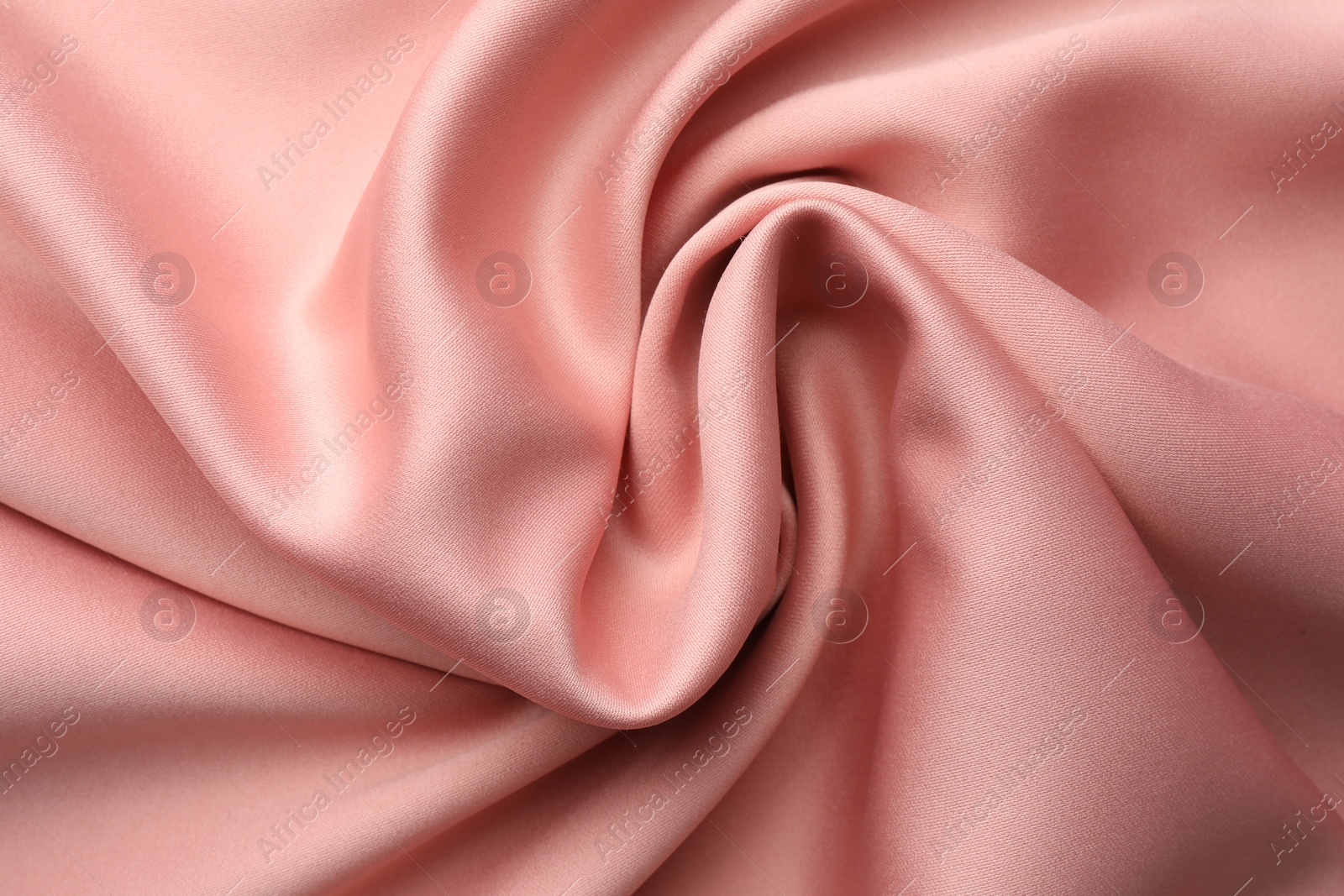 Photo of Crumpled pink silk fabric as background, top view