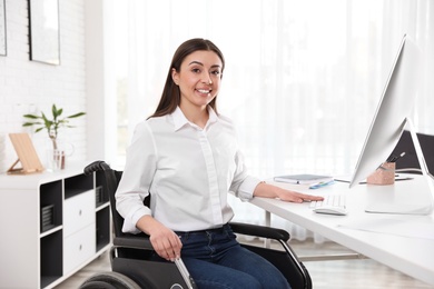 Photo of Portrait of woman in wheelchair at workplace